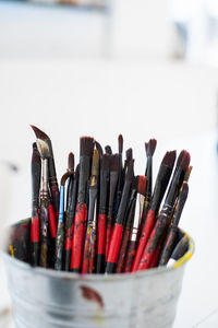 Jar full of used paintbrushes. vertical image with empty copy space.