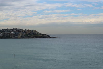 Scenic view of sea and buildings against sky