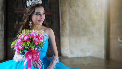 Beautiful woman holding flower bouquet