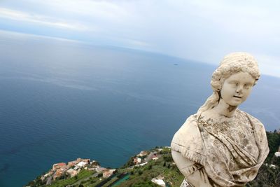 High angle view of statue against sea and sky