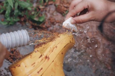 Close-up of hand cleaning boot