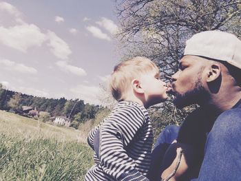 Side view of boy kissing father