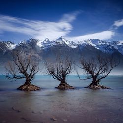 Scenic view of snowcapped mountains against cloudy sky