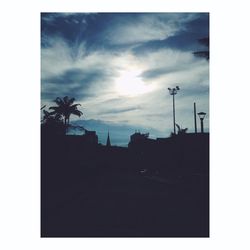 Silhouette of building against cloudy sky