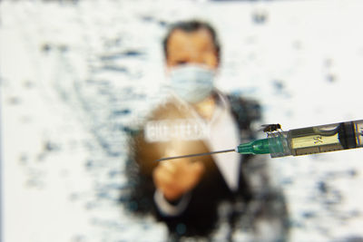 Close-up of man holding umbrella