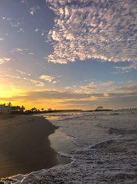 Scenic view of beach against sky during sunset