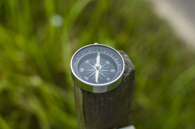 Close-up of navigational compass on wood
