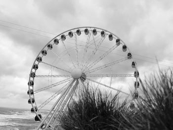 Low angle view of ferris wheel against sky