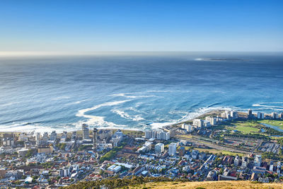 High angle view of townscape by sea against sky