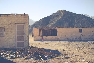 View of abandoned building against mountain range