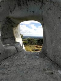 View of old ruin tunnel against sky