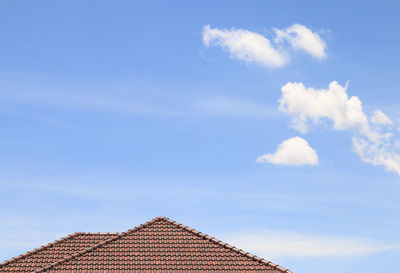 Low angle view of building roof against sky