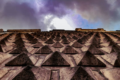 Low angle view of building roof against sky