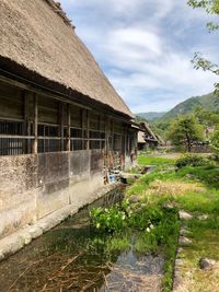 View of house by building against sky