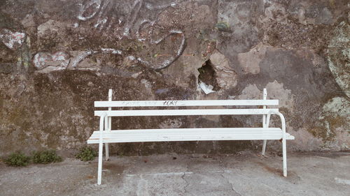 Close-up of empty seat against trees