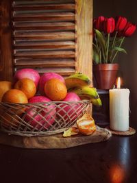 Various fruits in basket on table