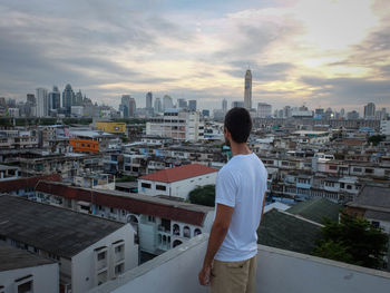 Rear view of man looking at city