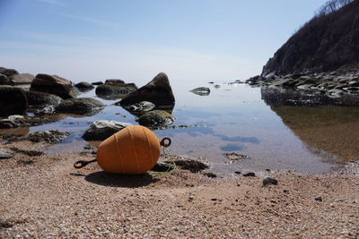 Stack of rocks at beach against sky