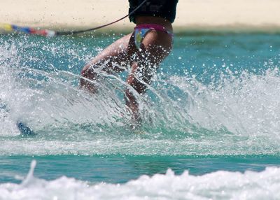 Woman surfing in sea