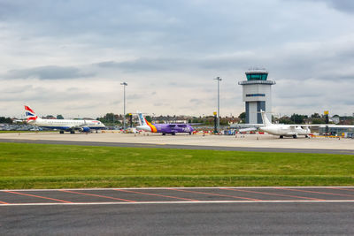 View of airplane at airport runway against sky