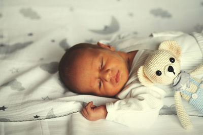 Cute baby girl sleeping on bed