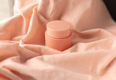 Jar of cream in color peach fuzz