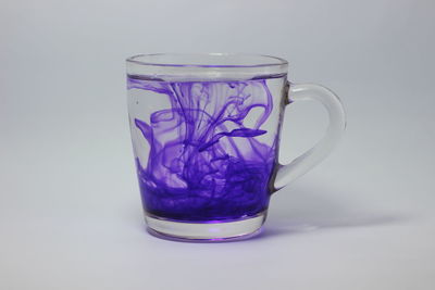 Close-up of drink served on table against white background