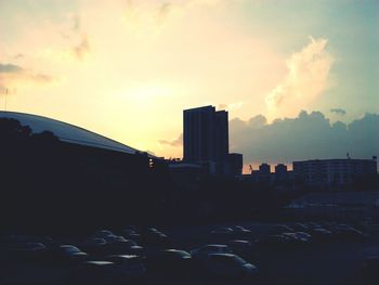 Buildings against sky at sunset