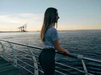 Side view of woman standing on boat deck