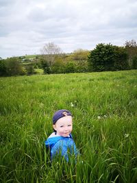 Full length of man on grassy field against sky