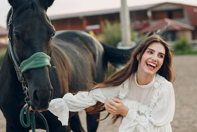 Portrait of young woman with horse