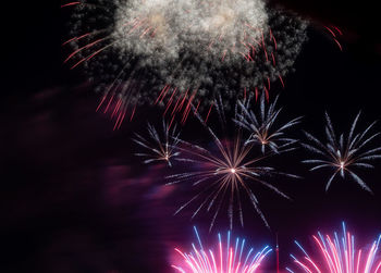 Low angle view of firework display at night