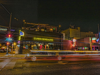 Light trails on road against sky at night