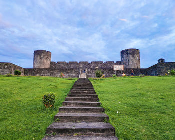 Old ruin building against cloudy sky