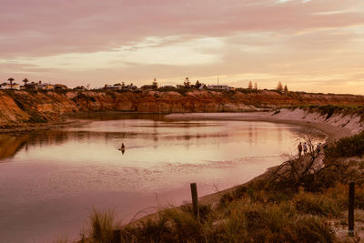 Scenic view of lake against sky during sunset