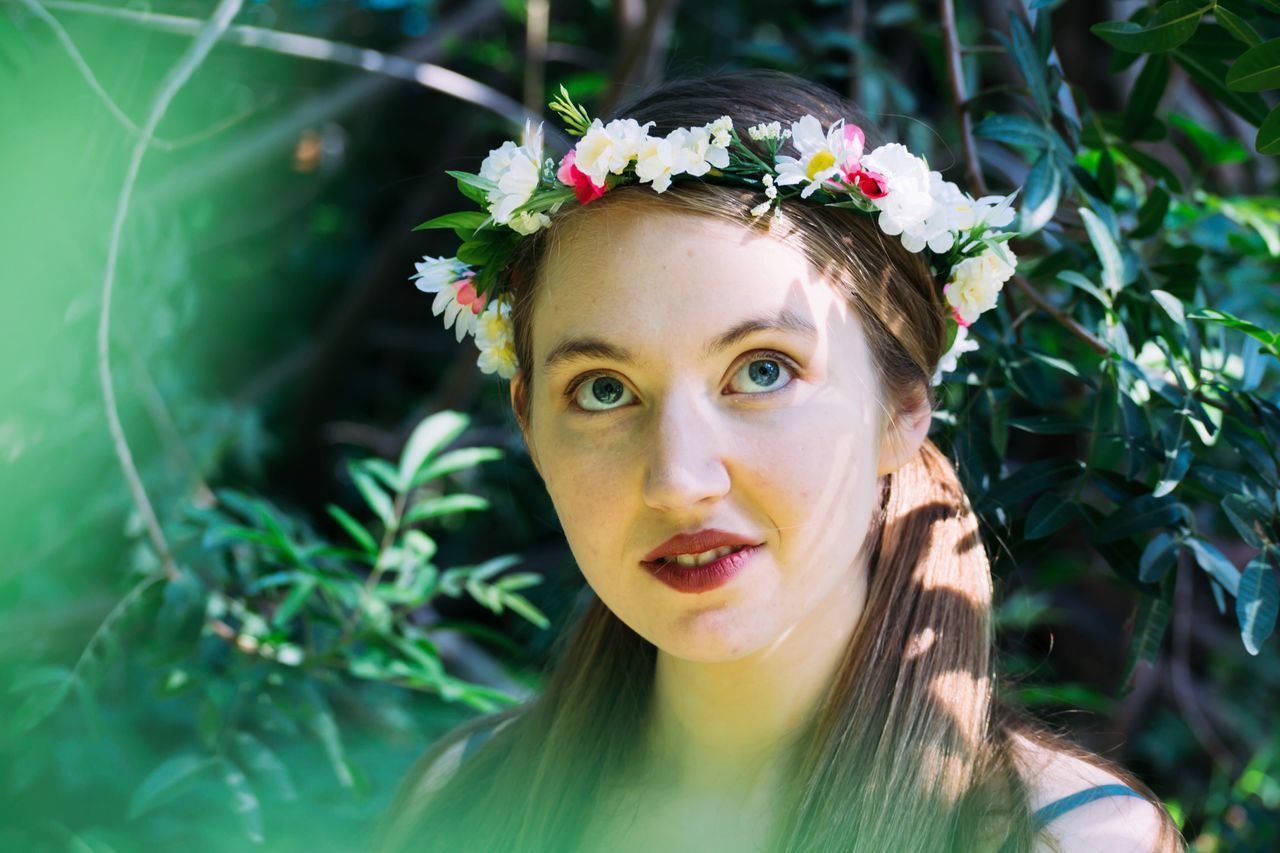 young adult, portrait, flower, beauty, young women, beautiful people, one person, adult, green color, one young woman only, adults only, wreath, headshot, only women, beautiful woman, women, nature, people, beauty in nature, outdoors, one woman only, close-up, human body part, grass, day, freshness