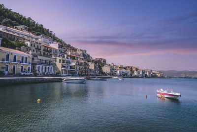 Scenic view of sea by buildings against sky