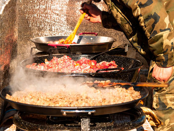 Person preparing food on barbecue grill