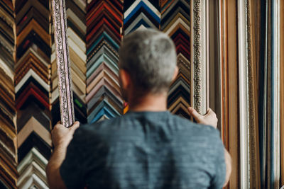 Rear view of man sitting on sofa at home