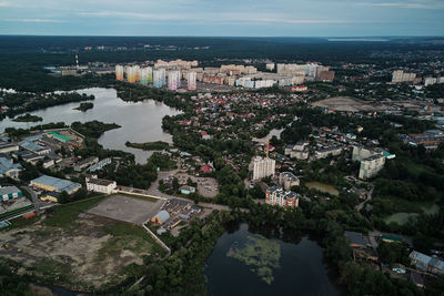 High angle view of buildings by sea against sky