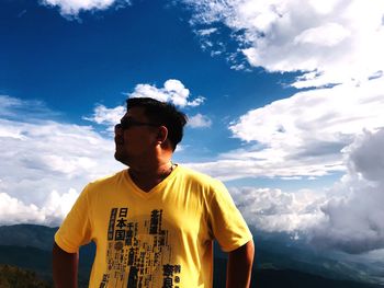 Man standing on mountain against sky