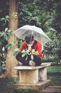 Man holding umbrella in rain