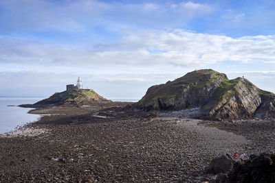 View of rock formation on beach against sky