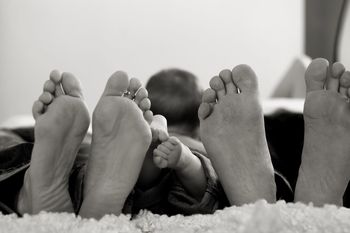 Close-up of family lying in bed