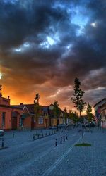 Houses and buildings against sky at sunset