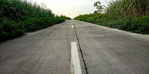 Surface level of empty road against sky