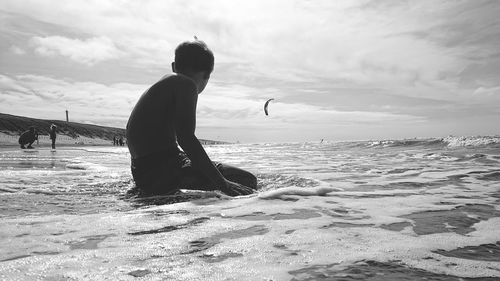 Man on beach against sky