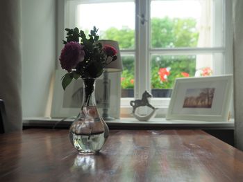 Flower vase on table at home