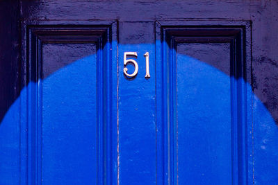 House number 51 on a blue wooden front door