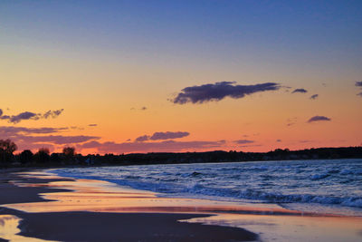 Scenic view of beach against sky during sunset